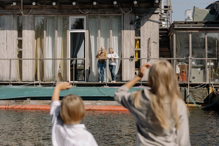 Kids Waving To Elderly Couple