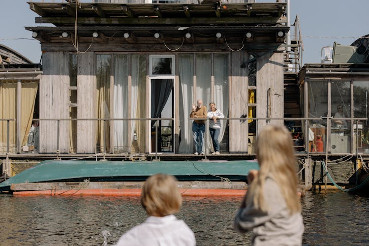 Grandparents Standing On A Boathouse