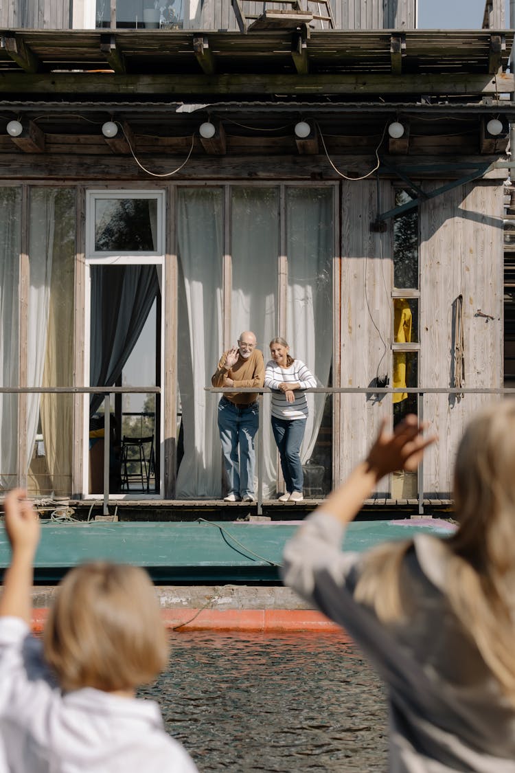 A Woman And Man Standing In A Houseboat