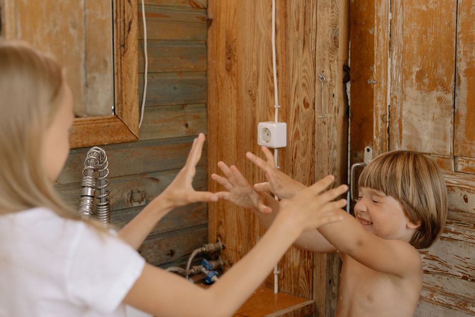 Photo by cottonbro studio on Pexels Joyful siblings playing together in a rustic bathroom setting. Warm wood tones and laughter fill the scene. - Photo by cottonbro studio on Pexels
