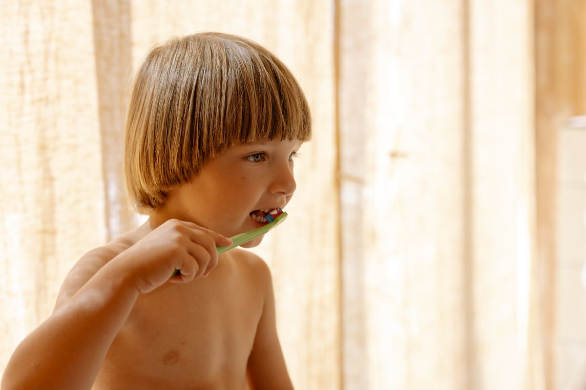 Youth athlete holding a sports mouthguard