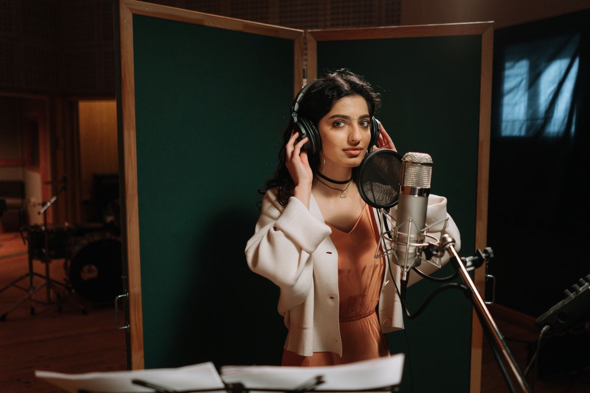 Singer preparing to record in front of a studio microphone