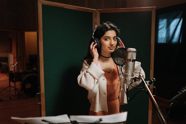 A Beautiful Female Artist Recording A Song