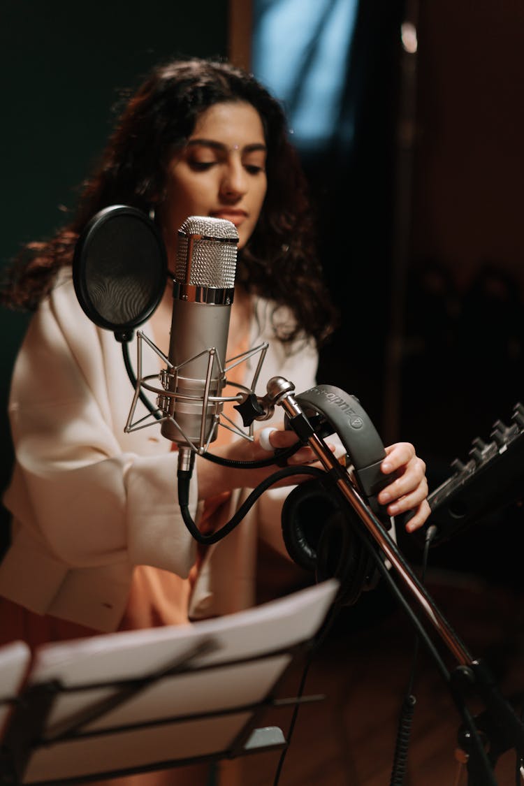 A Female Artist Getting The Headphones