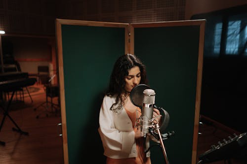 A Female Artist Recording a Song