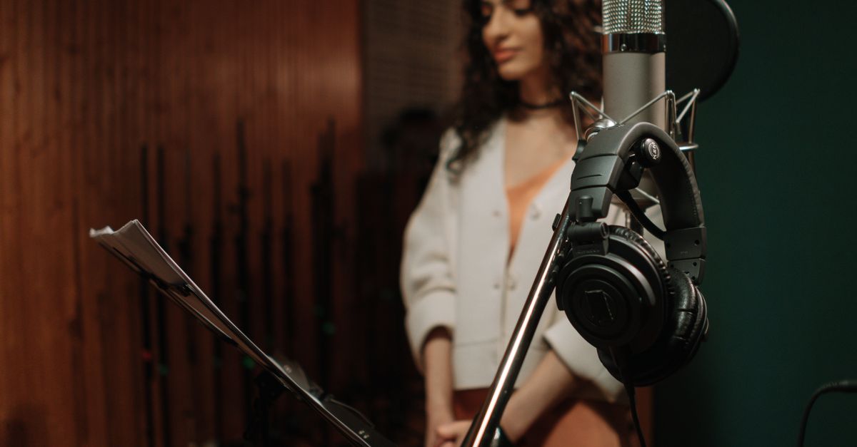 Pastor Prince D recording in a modern studio with headphones and microphone