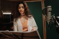 Pretty Female Artist Reading the Lyrics of the Song