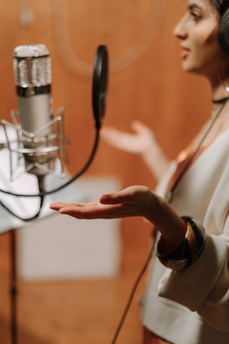 A Female Artist Recording A Song