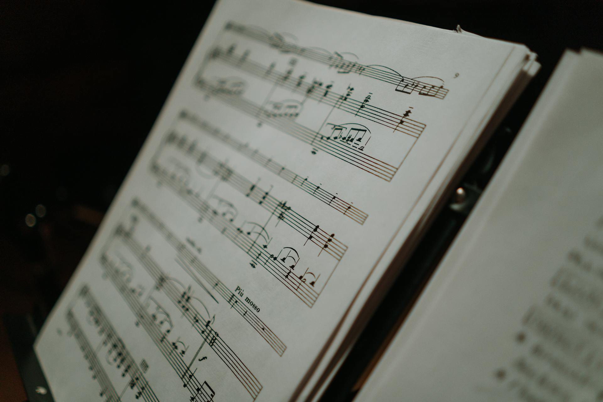 Close-up of sheet music displaying musical notes on a stand, perfect for musical compositions and practice.