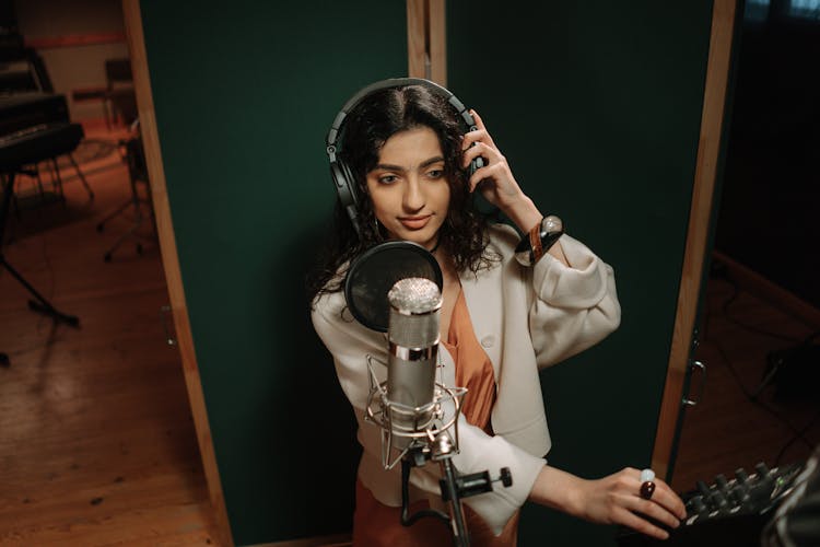 A Female Artist Recording A Song