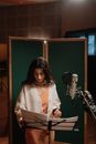 Female Artist Reading the Lyrics of the Song