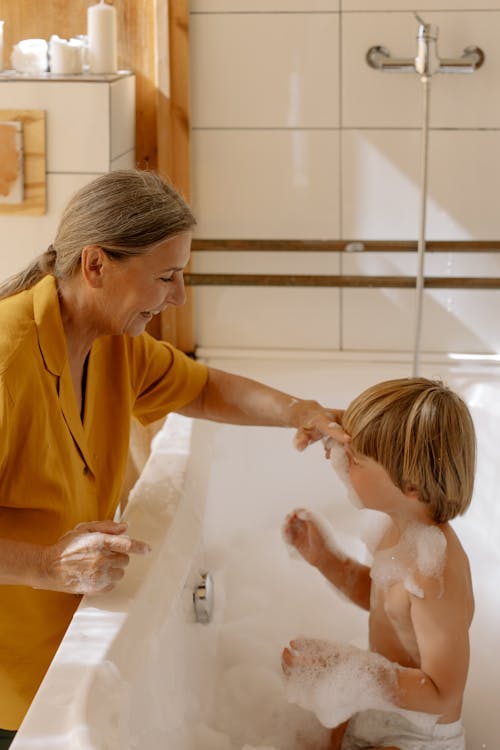 Free Grandmother Putting Bubbles on Her Grandson's Face Stock Photo