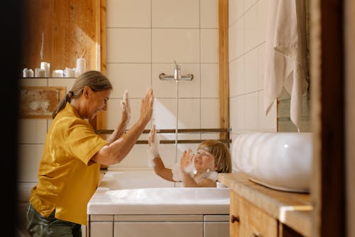 Grandmother Helping Her Grandson Take a Bath