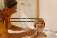 Grandmother Helping Her Grandson Take a Bath
