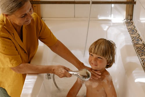 Grandmother Giving Her Grandson a Bath