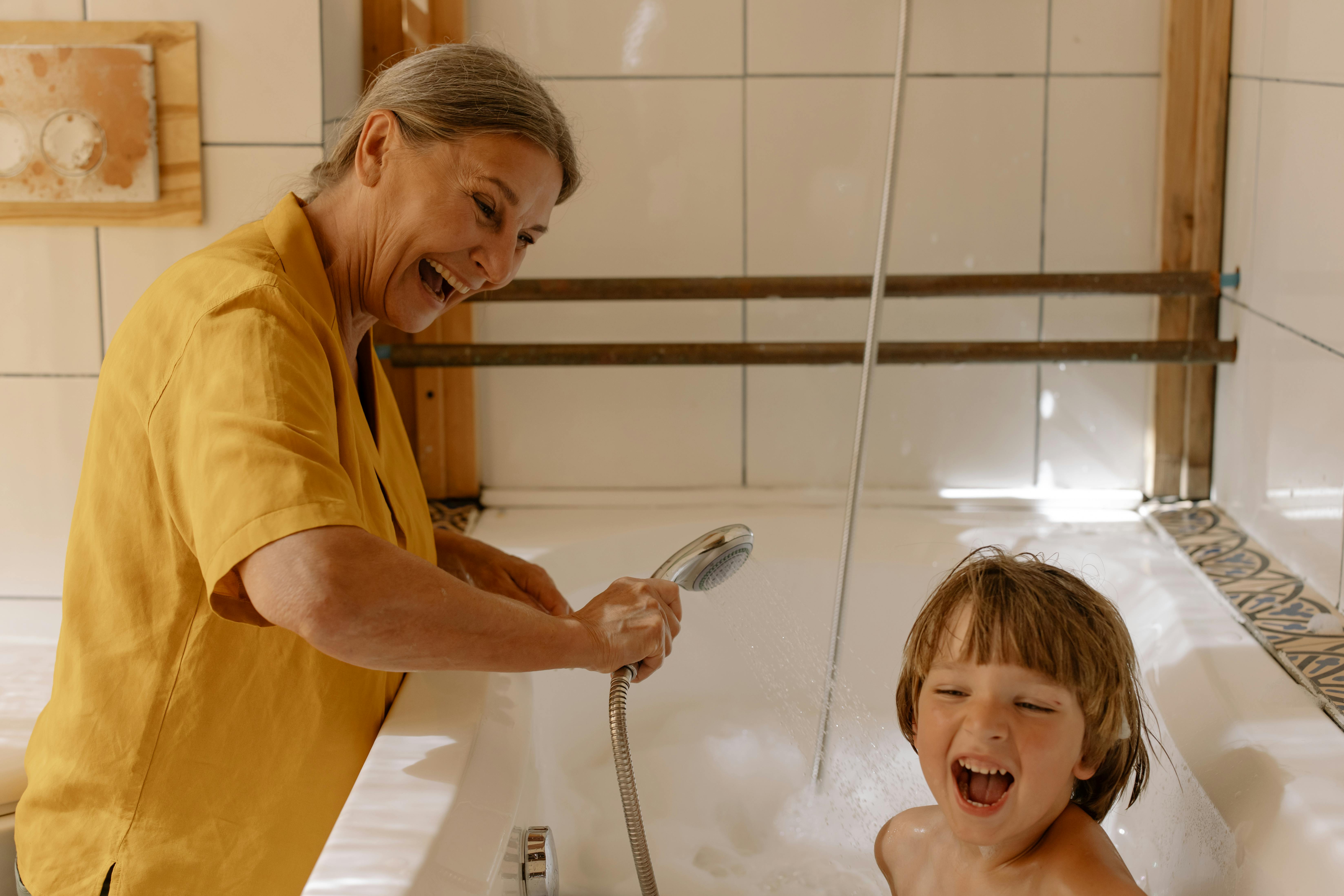 grandmother giving her grandson a bath