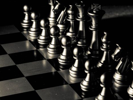 Close-up of a chessboard with pieces set for a strategic game, symbolizing intellect and planning.