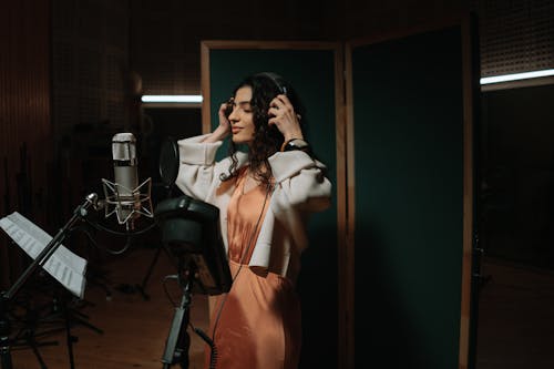 A Female Artist Recording a Song