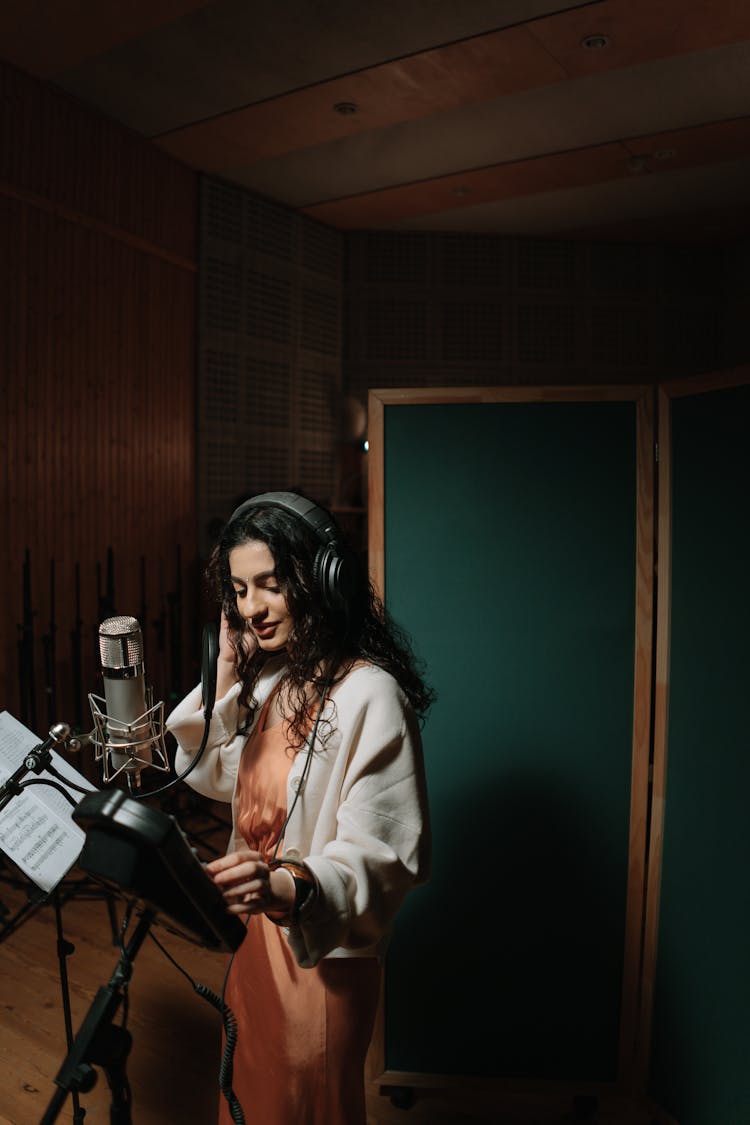 A Female Artist Recording A Song