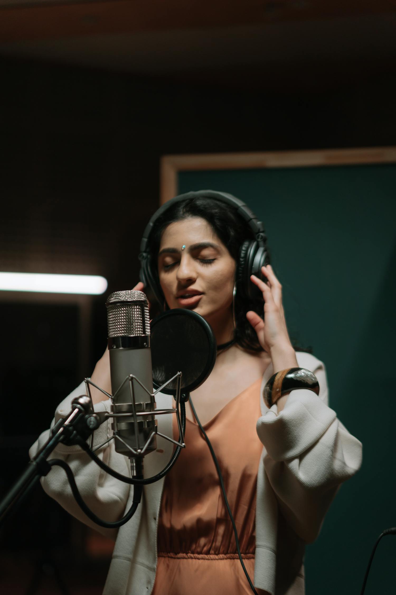 Female singer recording in studio