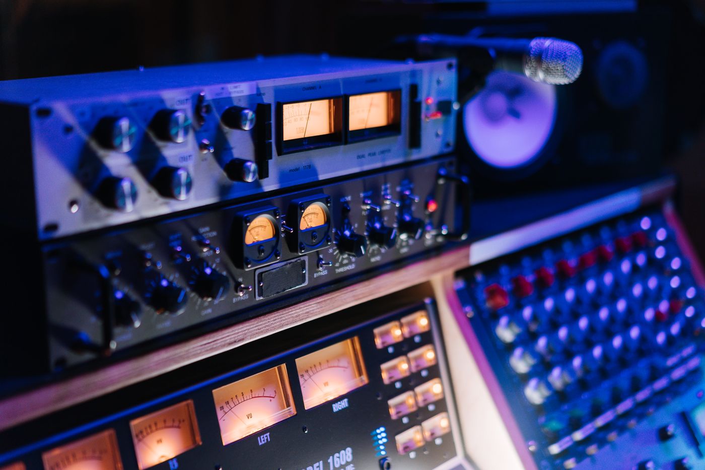 Professional music production setup with keyboard and studio monitor