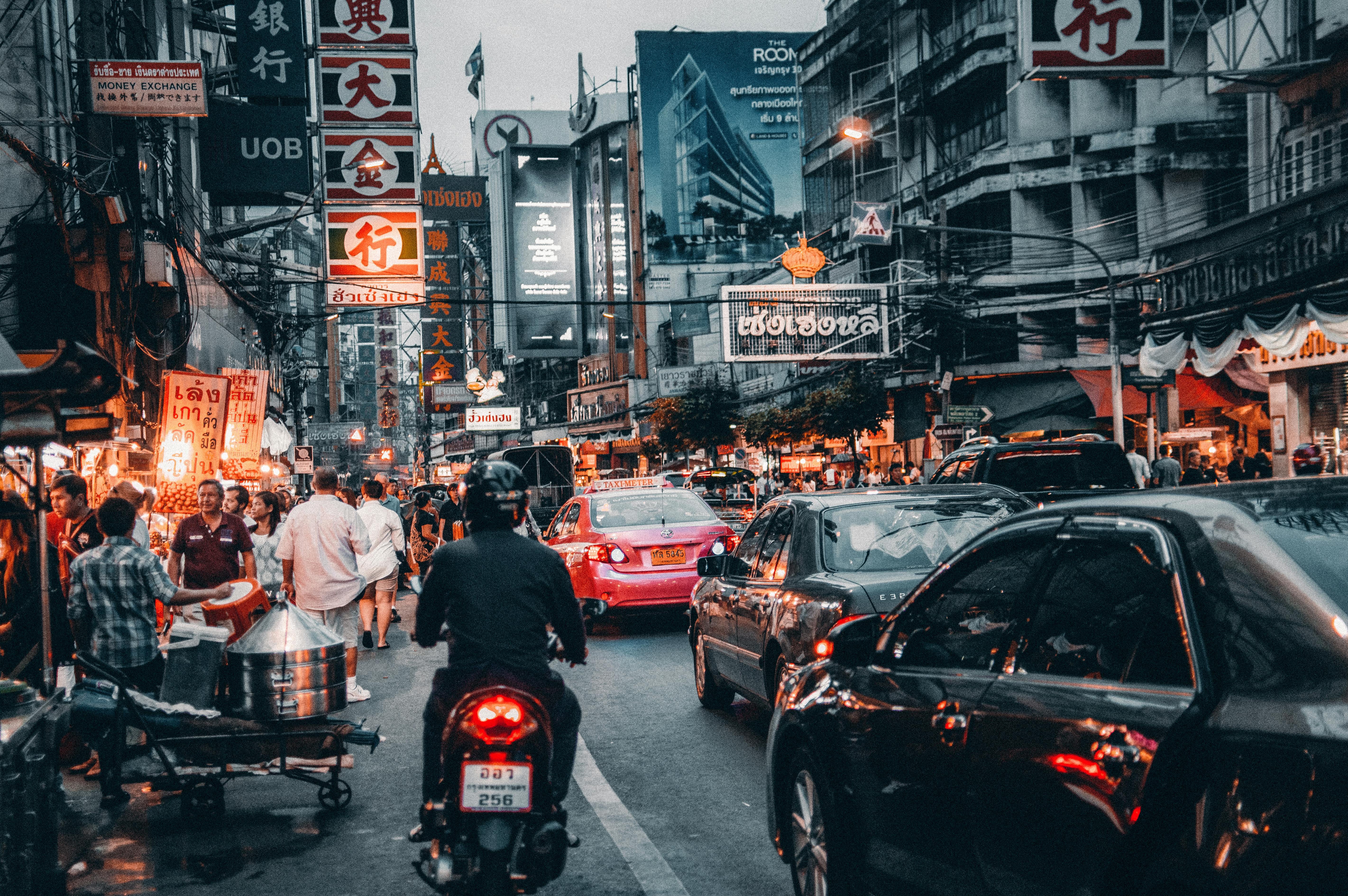 crowded street with cars passing by