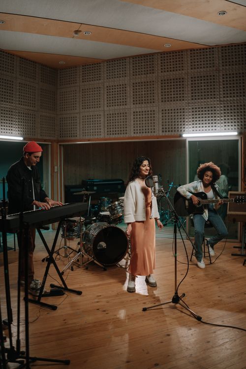 Free A diverse band rehearsing in a music studio with various instruments. Stock Photo