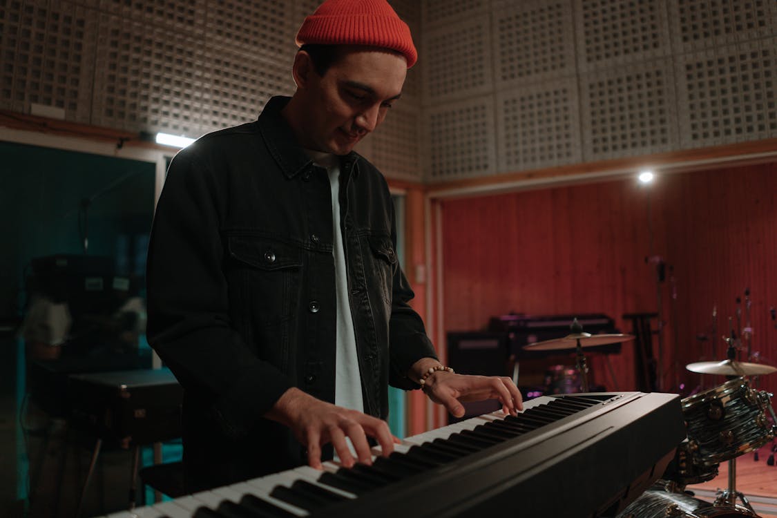 Man in Black Jacket Playing Keyboard