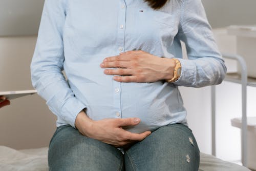 Free Photo Of Person Holding Her Stomach Stock Photo