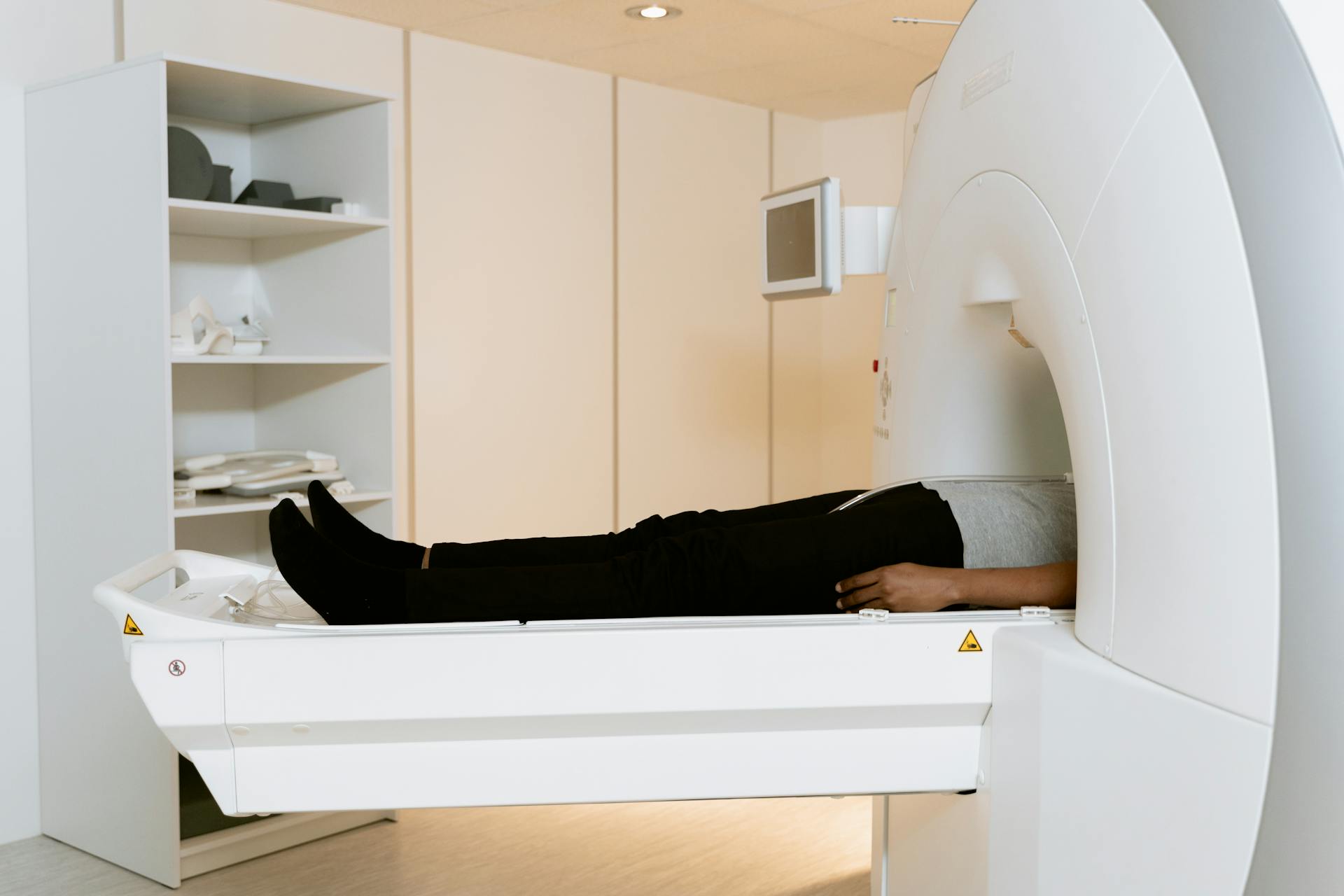 Photo Of Person Laying Down On A CAT Scanner