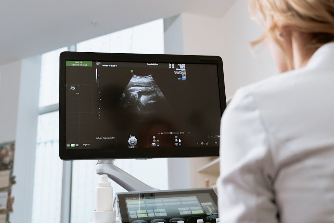 Free Photo Of An OB-GYN Looking In The Monitor Stock Photo