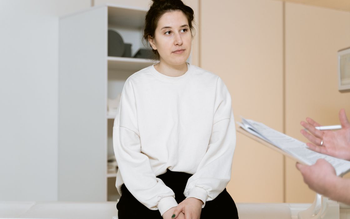 Woman listening attentively during a consultation with a doctor in a clinic