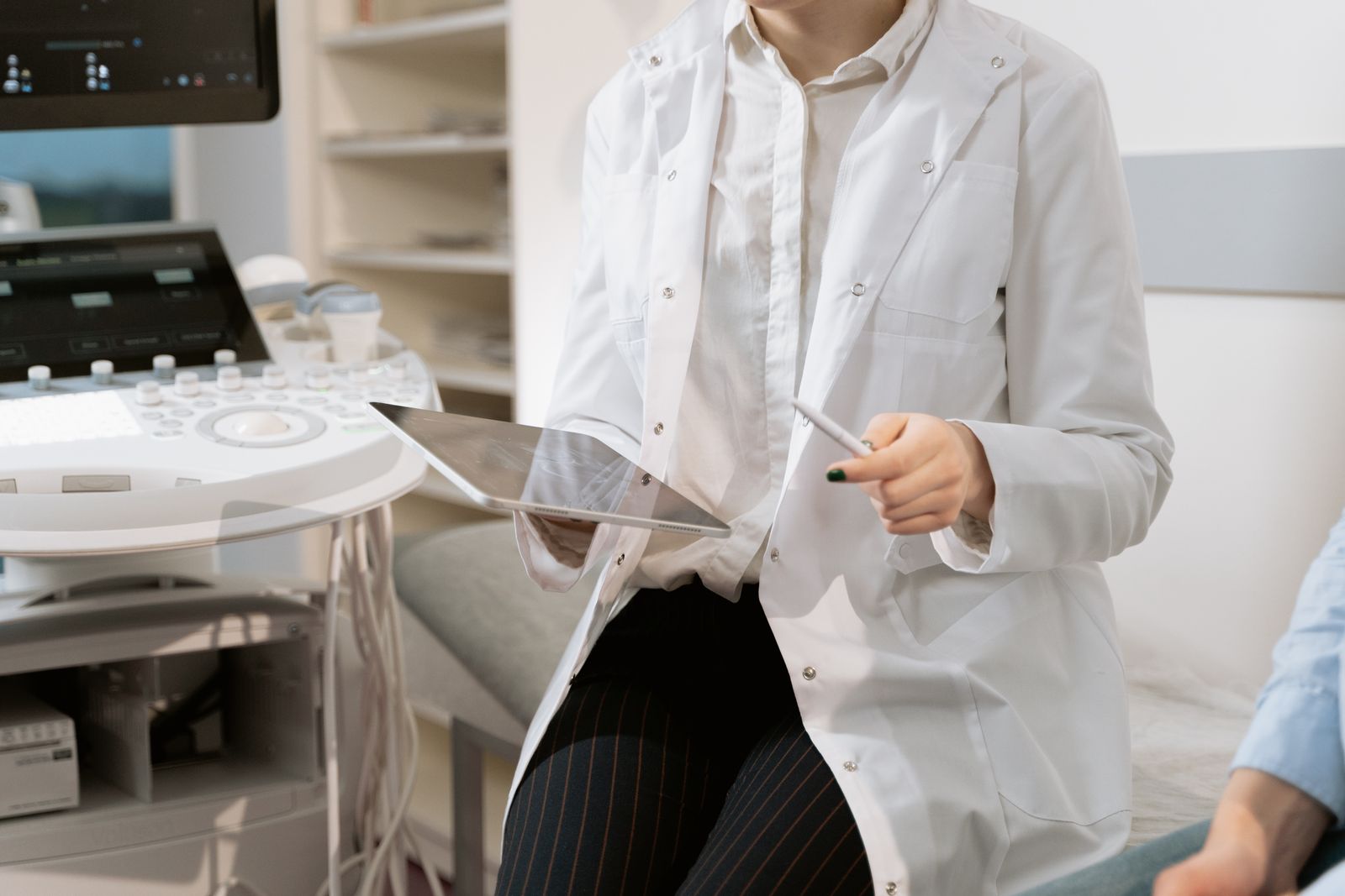 Surgeon reviewing knee MRI images with a patient