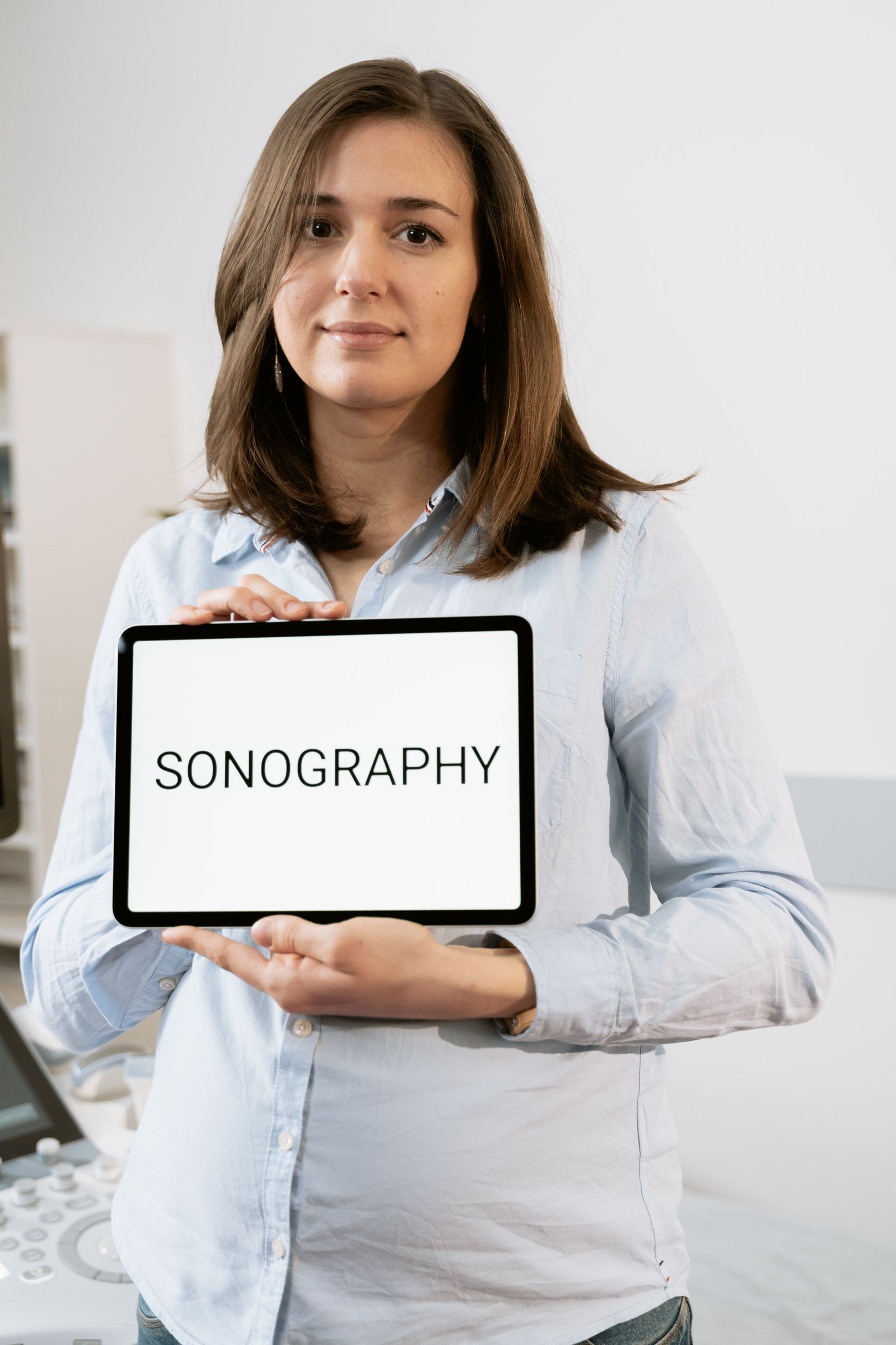 Pregnant person resting with lower-leg swelling context for choosing compression socks. Photo: Pexels.