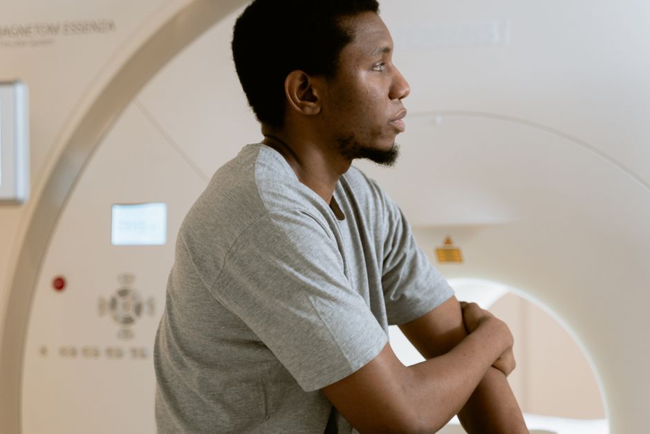 Imaging professional preparing a patient for a magnetic resonance scan in Radiology Imaging professional preparing a patient for a magnetic resonance scan in Radiology