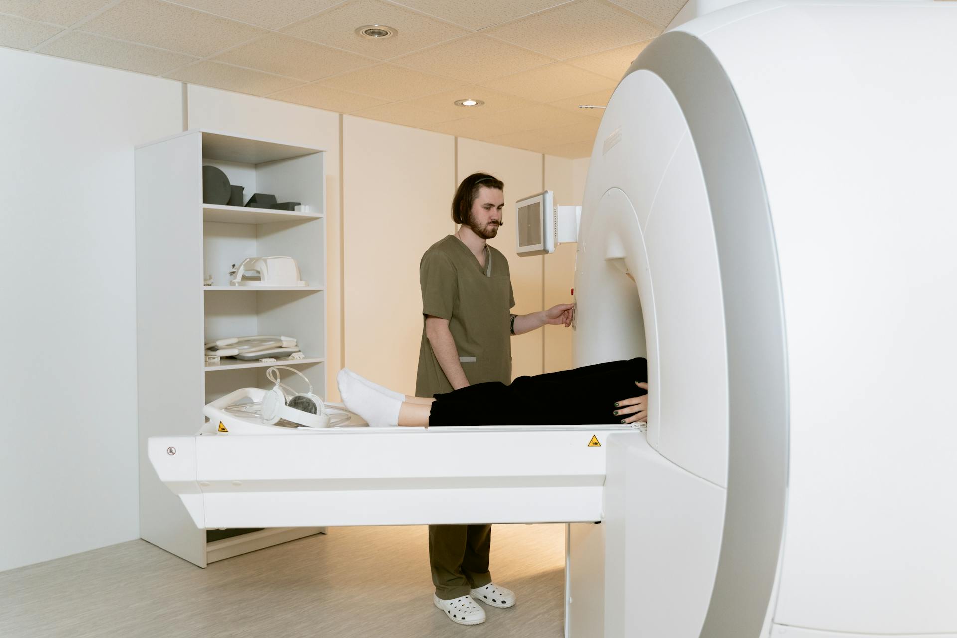 Photo Of Radiologist Operating The CT Scanner