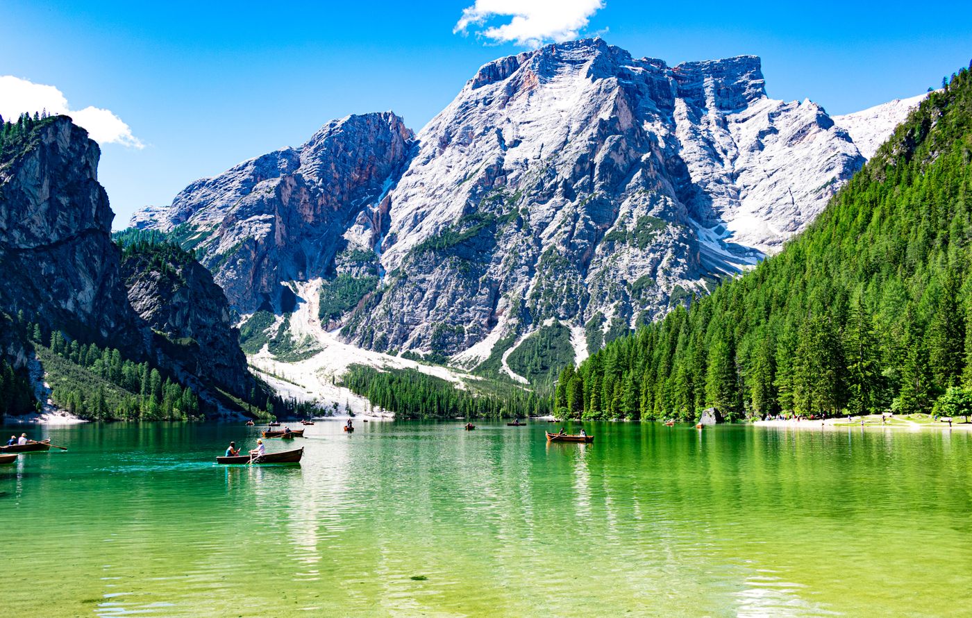 Dramatic Alpine peaks under blue sky above a valley