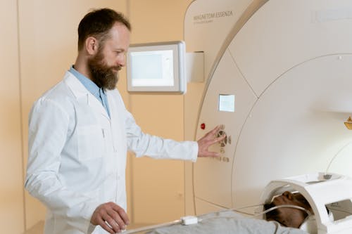 Photo Of Medical Practitioner Operating The CAT Scanner