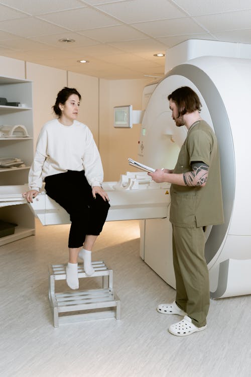 Photo Of Woman Sitting On A CT Scan Machine