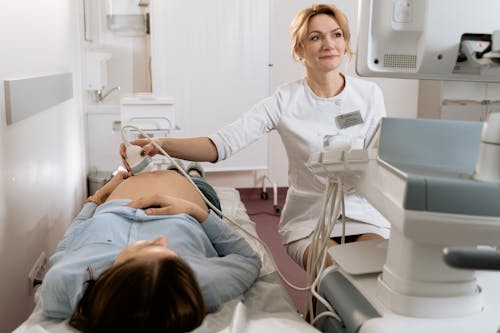 Photo Of Gynecologist Doing An Ultrasound On A Pregnant Woman