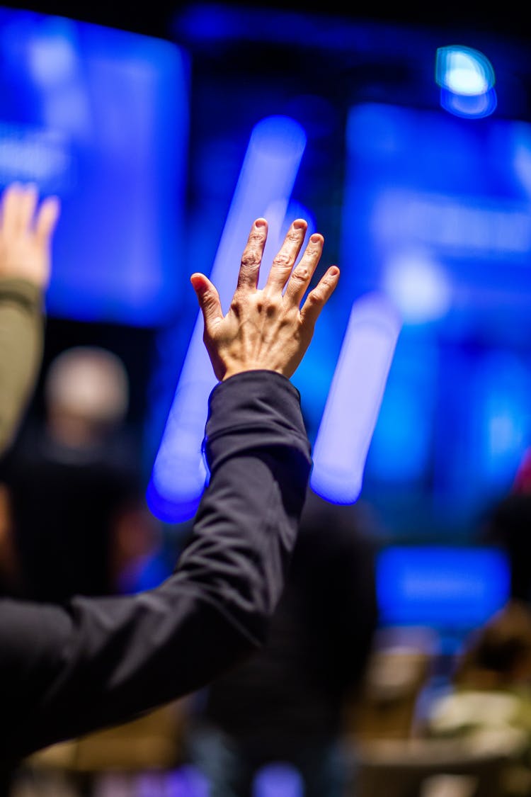 Man Raising Hand At Concert In Club