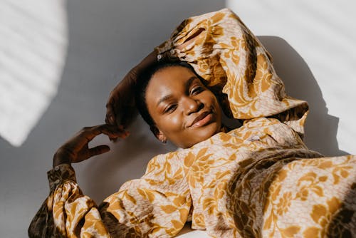 Woman in a Brown Long Sleeve Top Looking at the Camera