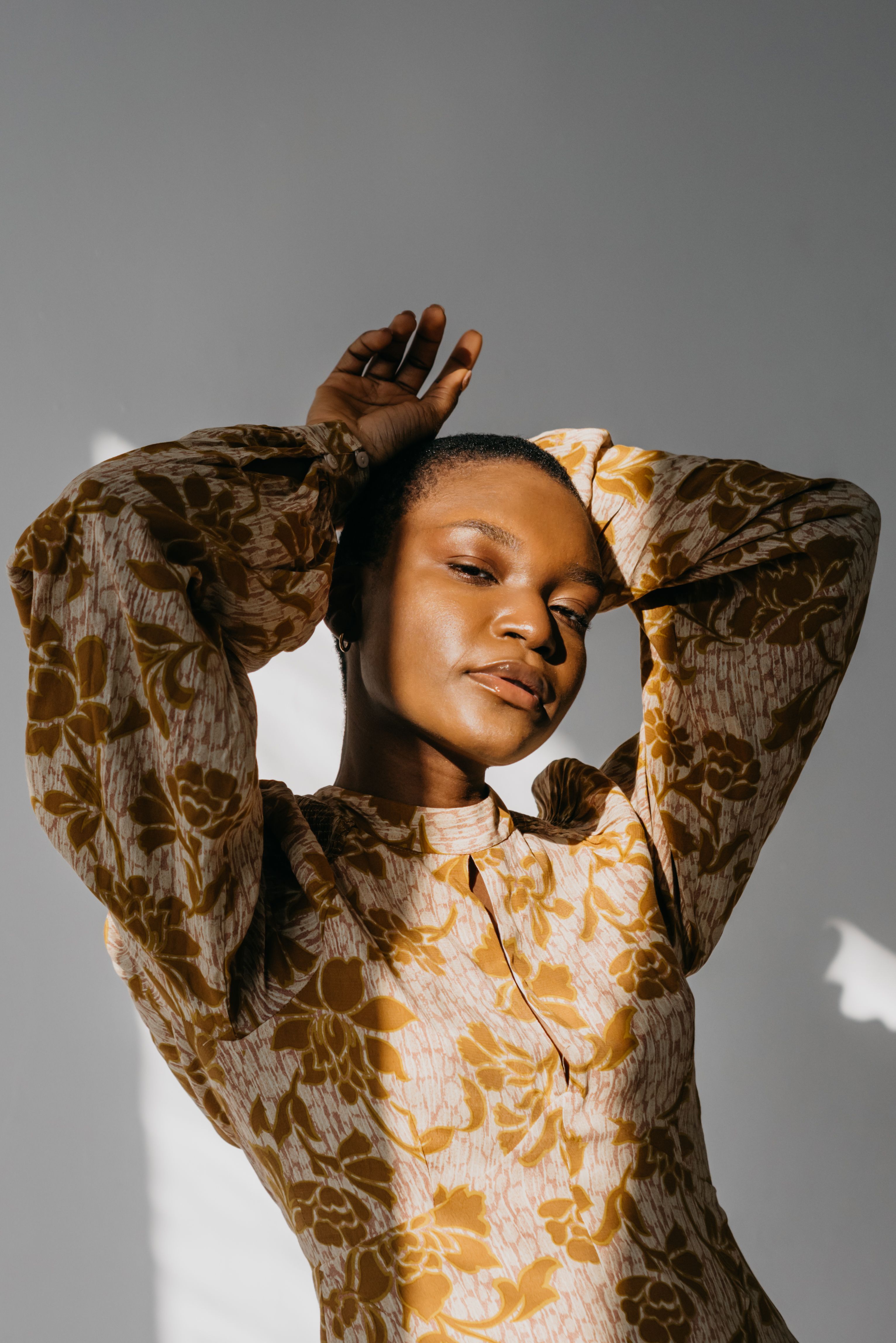 A Pretty Woman in Gold Floral Top Posing · Free Stock Photo