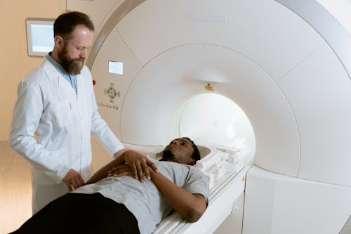 Photo Of Doctor Operating MRI Scanner