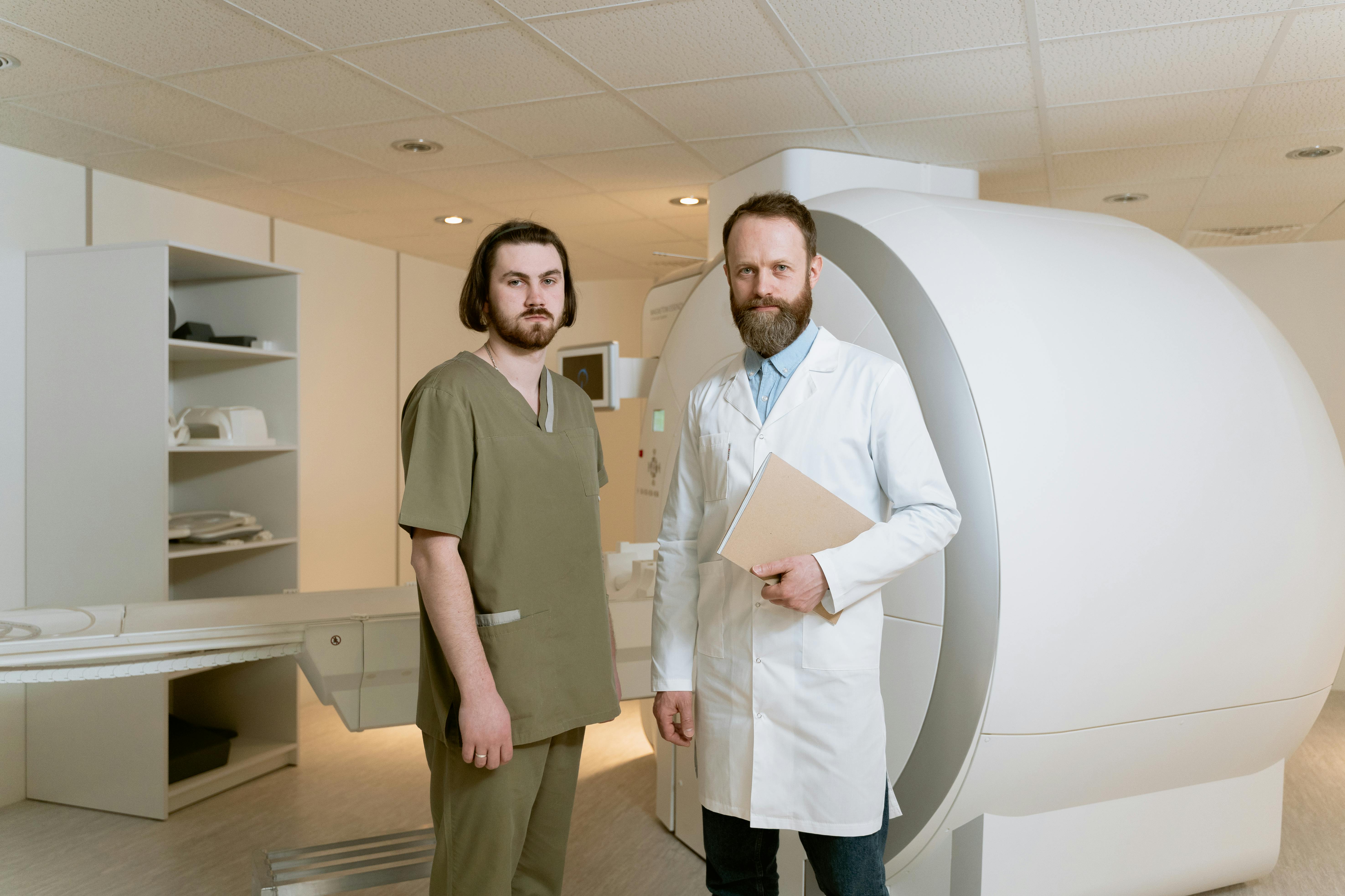 Doctors standing next to an MRI machine showcasing modern medical technology and professionalism.