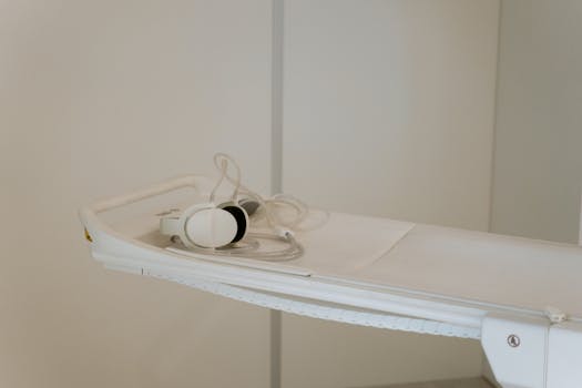 Close-up of medical examination equipment on a hospital bed, ready for use.