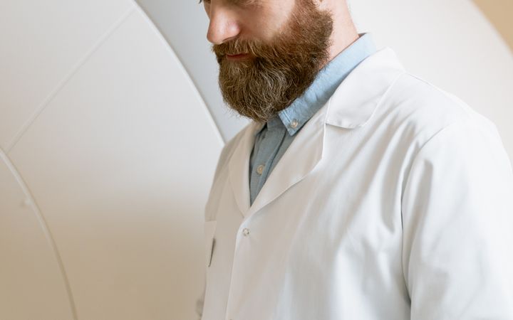 Doctor reviewing medical records in a hospital setting. Professional healthcare analysis.