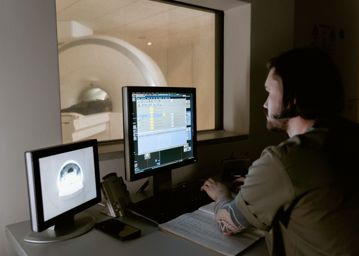 Radiology professional reviewing MRI images on a diagnostic workstation