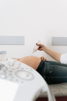 A pregnant woman receives an ultrasound exam in a medical clinic.