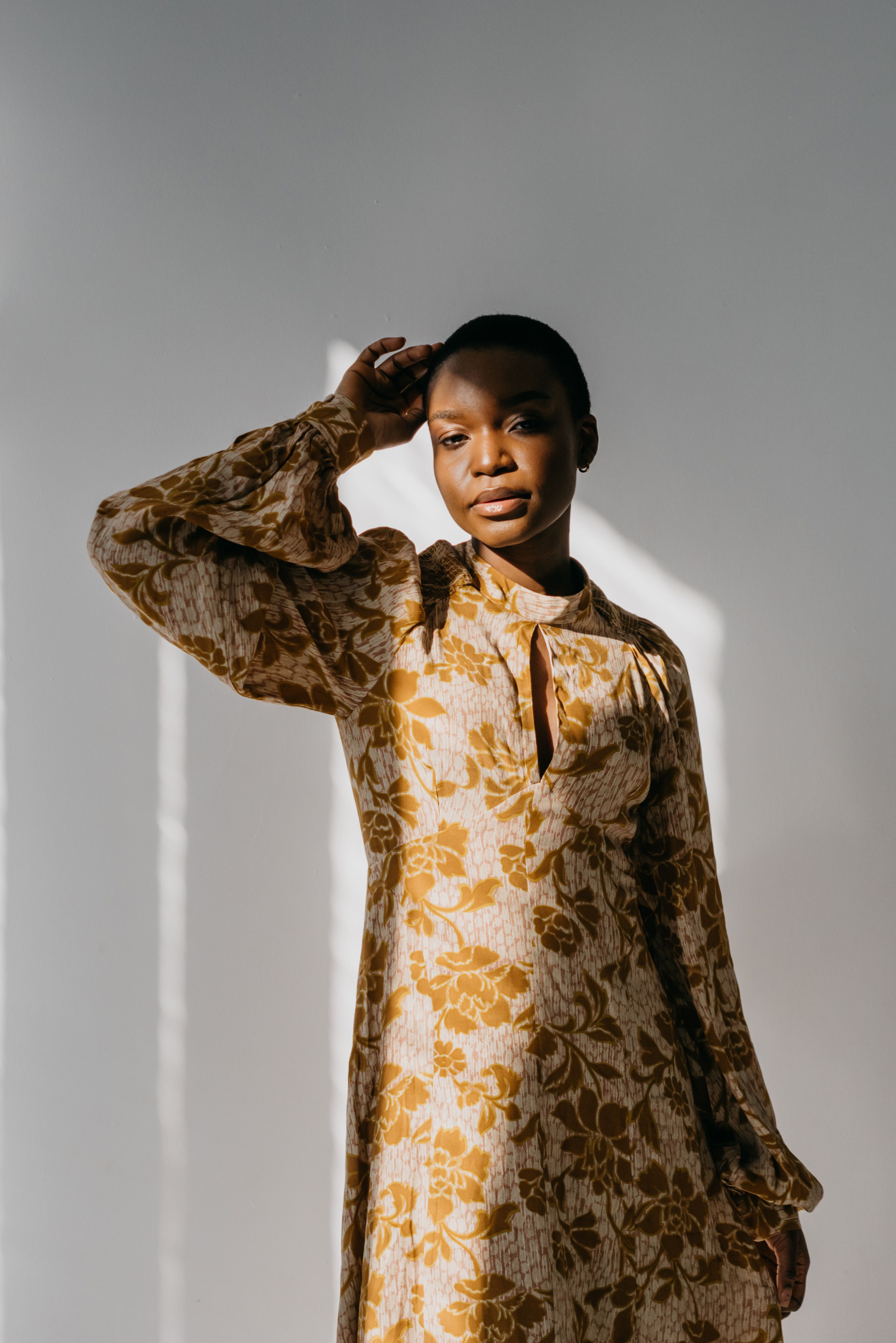 A Woman in Gold Floral Dress Posing · Free Stock Photo